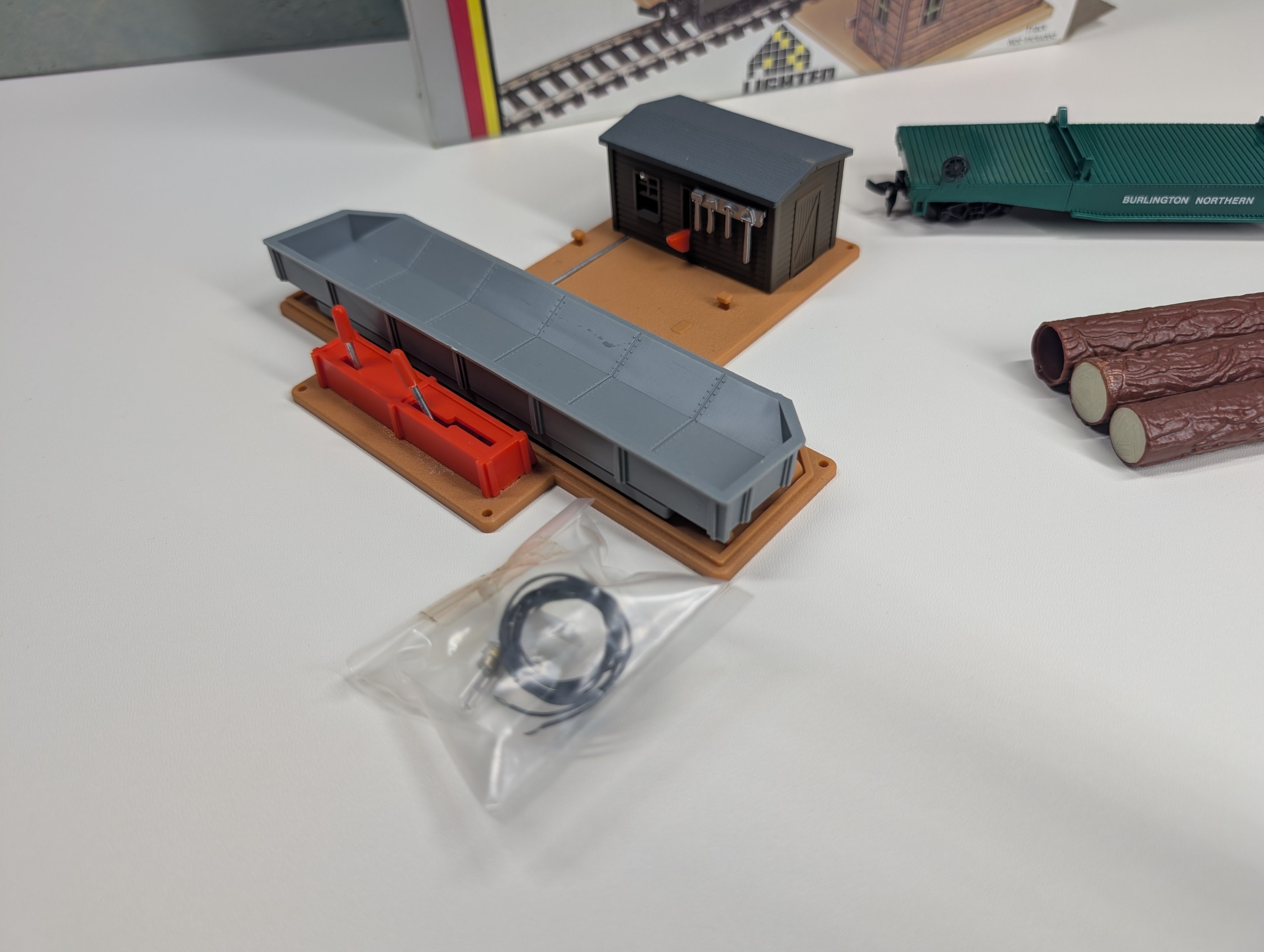 USED AHM 11011 HO Scale Operating Log Dump Car w/ Lighted Building